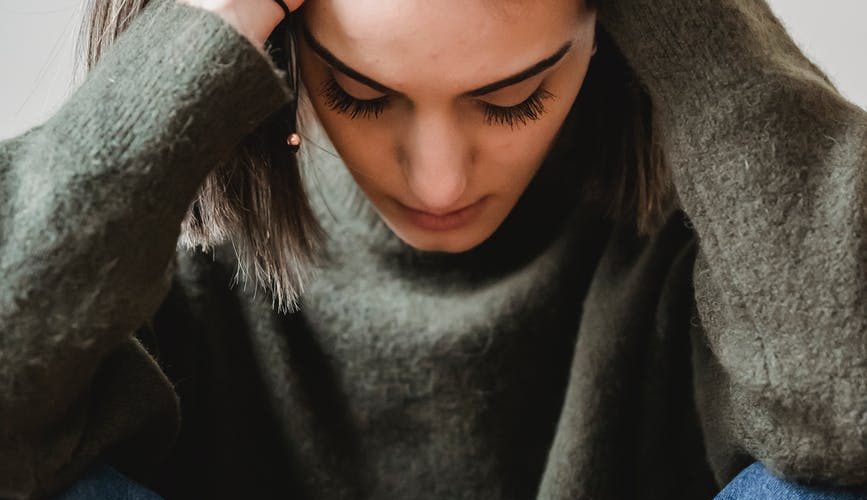 despaired woman touching head in room